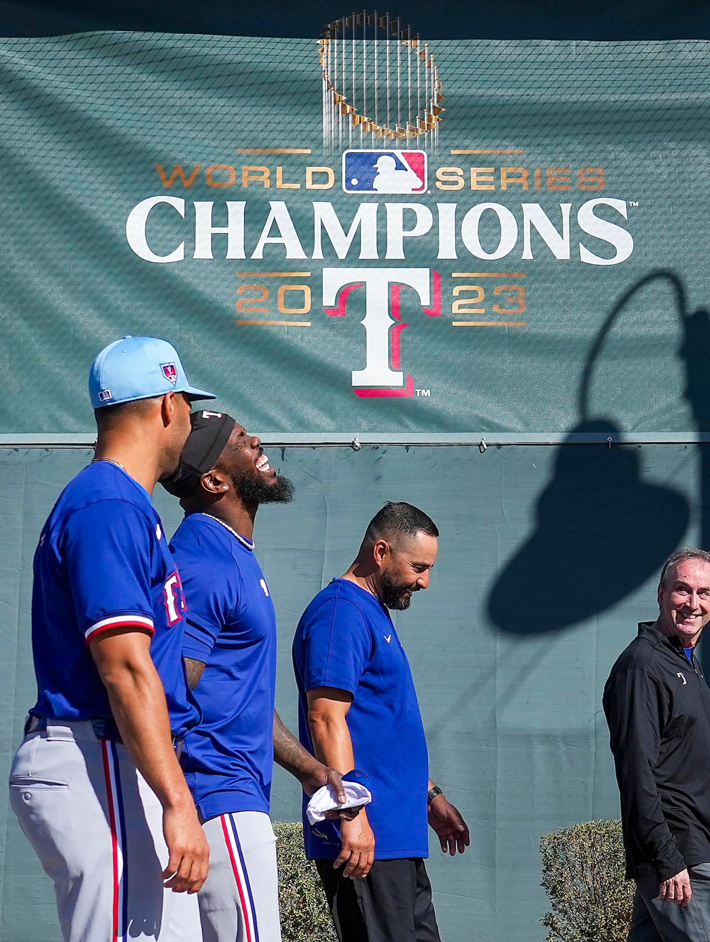 Texas Rangers outfielder Adolis García (53) laughs with infielder Marcus Semien (left) while...