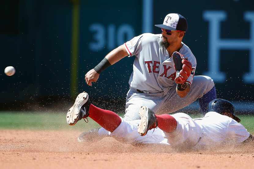 Boston Red Sox's Xander Bogaerts, bottom, steals second base as Texas Rangers' Rougned Odor...