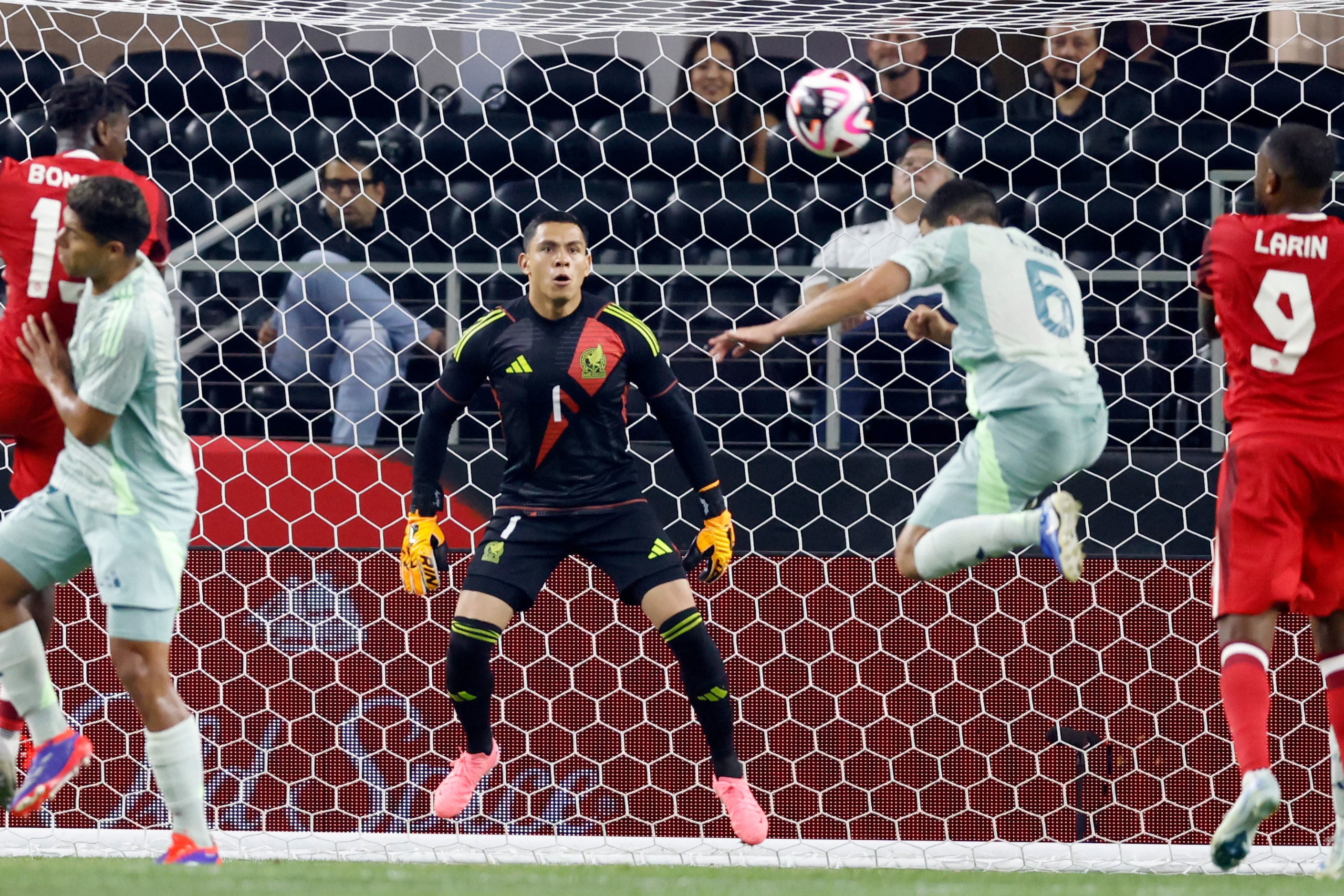 Mexico goalkeeper Angel Malagon (1) watches as midfielder Erik Lira (6) clears the ball from...