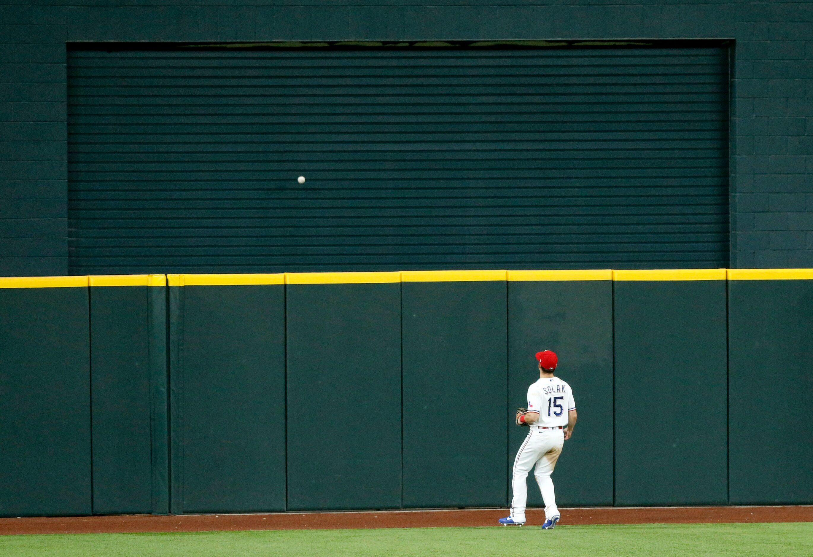 Texas Rangers center fielder Nick Solak (15) watches Seattle Mariners Dylan Moore's solo...