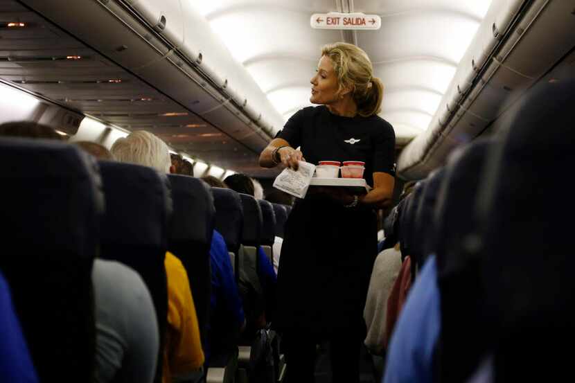  Southwest Airlines flight attendant Jenni Heikkinen hands out drinks on Southwest Airlines...