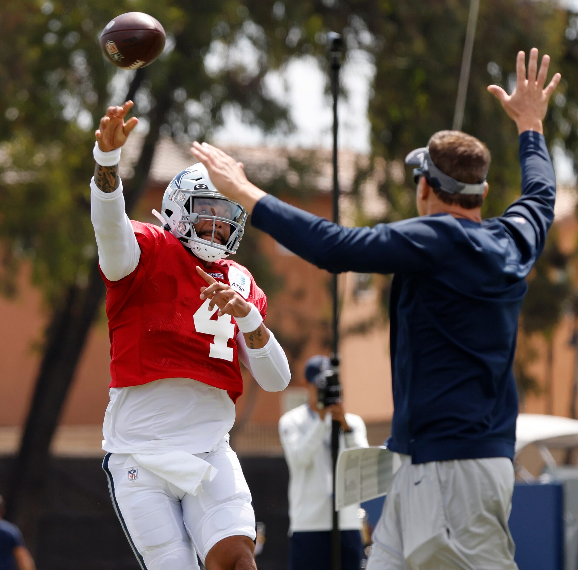 Dallas Cowboys quarterback Dak Prescott (4) throws under pressure during training camp...