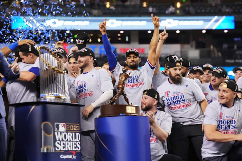Texas Rangers’ Marcus Semien, center, celebrates winning the World Series after defeating...