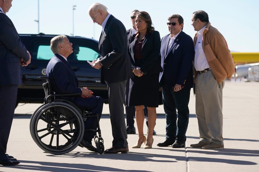 President Joe Biden holds a letter given to him by Texas Gov. Greg Abbott that outlined laws...