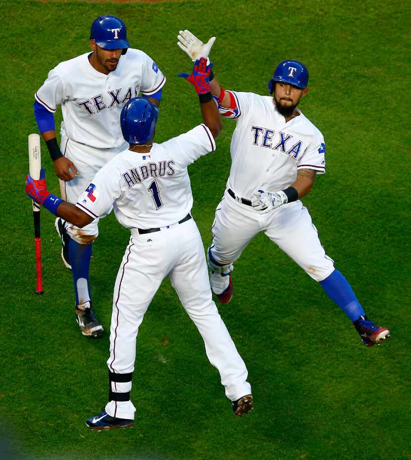 Texas Rangers second baseman Rougned Odor (right) is congratulated by teammate Elvis Andrus...