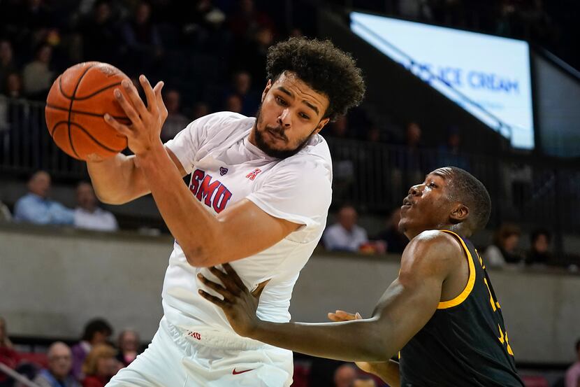 SMU forward Isiah Jasey (22) pulls down a rebound in front of East Carolina center Charles...