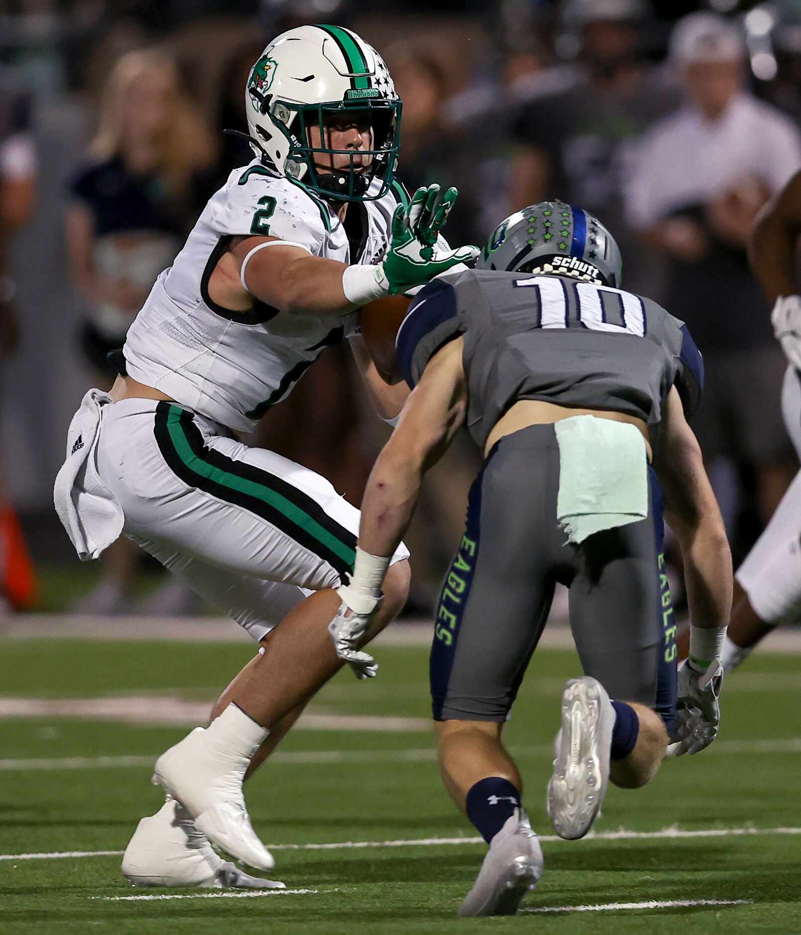 Southlake Carroll running back Owen Allen (2) tries to elude Eaton safety Aric Wood (10)...