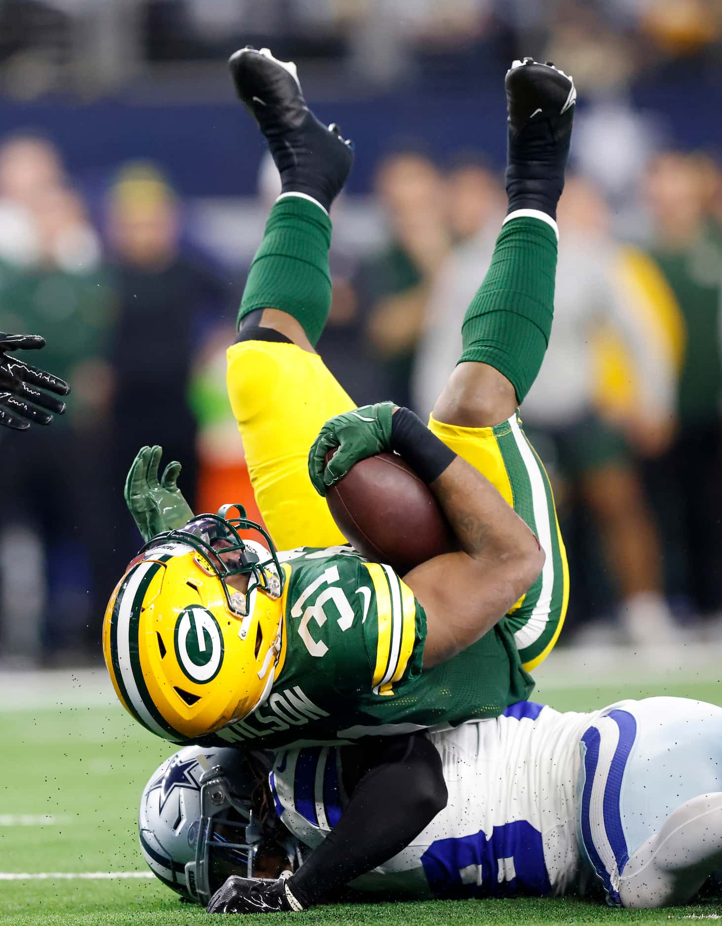 Green Bay Packers running back Emanuel Wilson (31) is upended by Dallas Cowboys safety Malik...