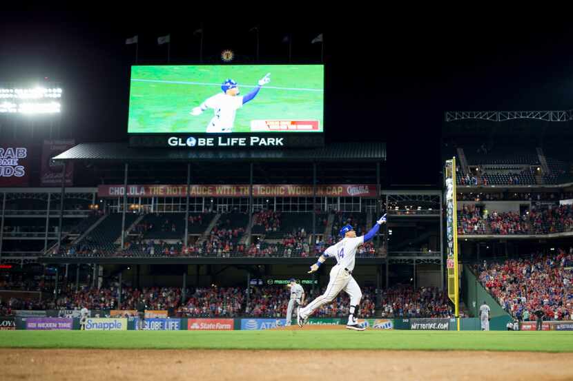 Texas Rangers left fielder Carlos Gomez (14) rounding 3rd  base celebrating a 3 run home run...