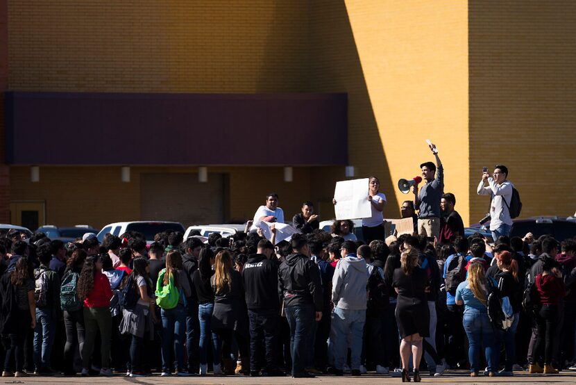 Students at Moises E. Molina High School walk out of class and rally in the parking lot in...