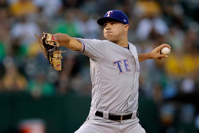 Texas Rangers pitcher Brock Burke works against the Oakland Athletics during the first...