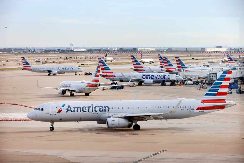 An American Airlines jet taxis to the runway after leaving a Terminal C gate at DFW...