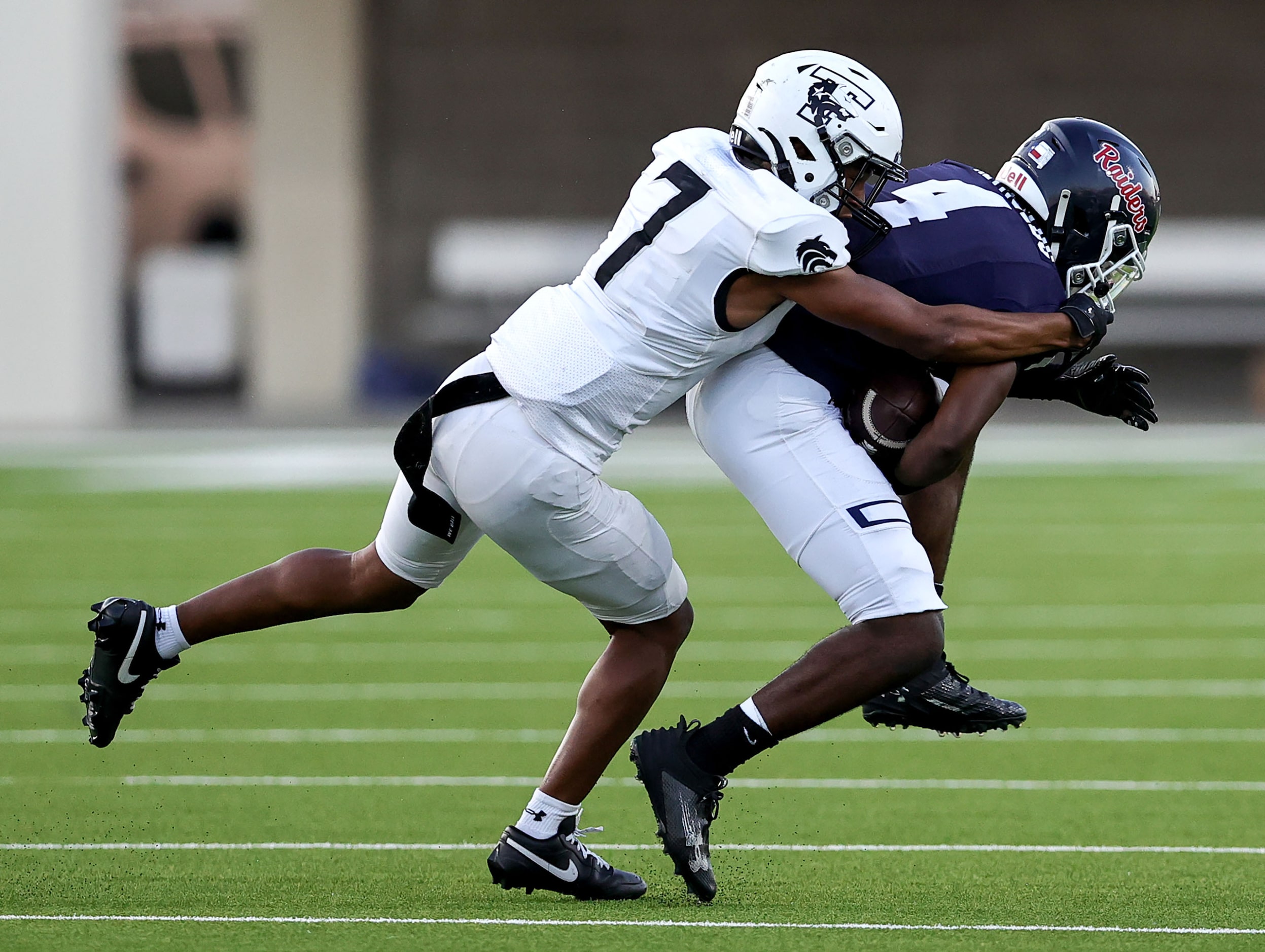 Denton Ryan running back Tre'Vaughn Reynolds (4)  is stopped immediately by Mansfield...