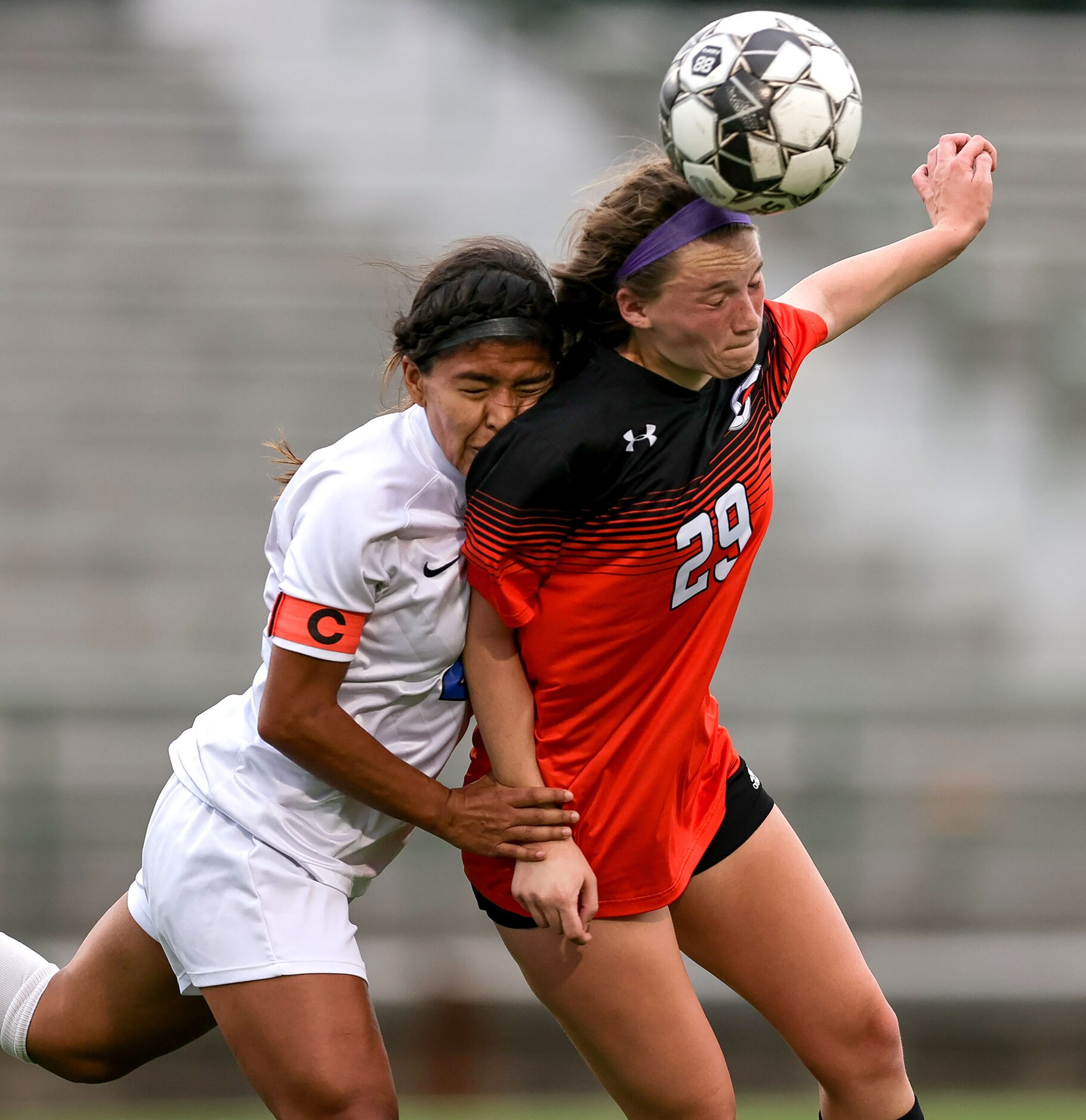 Rockwall Miranda Countryman (29) heads the ball against Duncanville Daisy Altamirano (L)...