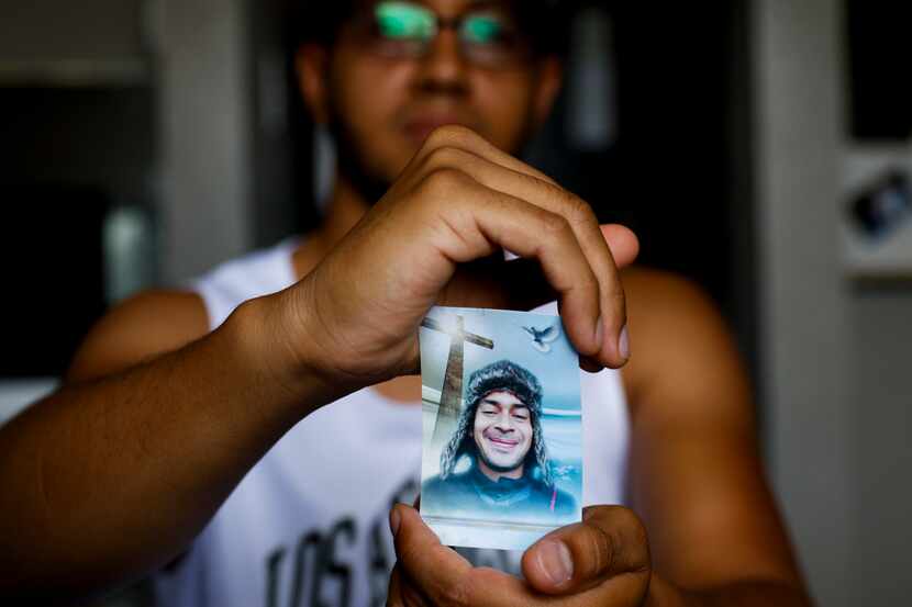 Daniel Seijas holds a photo of his longtime friend Elio Cumana, a victim of Allen Premium...
