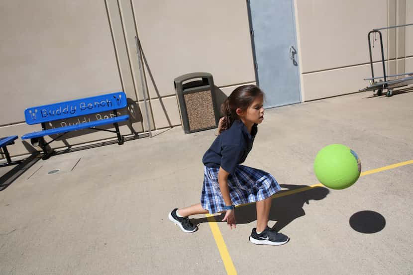 Fourth-grader Elisheva Wider plays near the Buddy Benches at Akiba Academy in North Dallas....