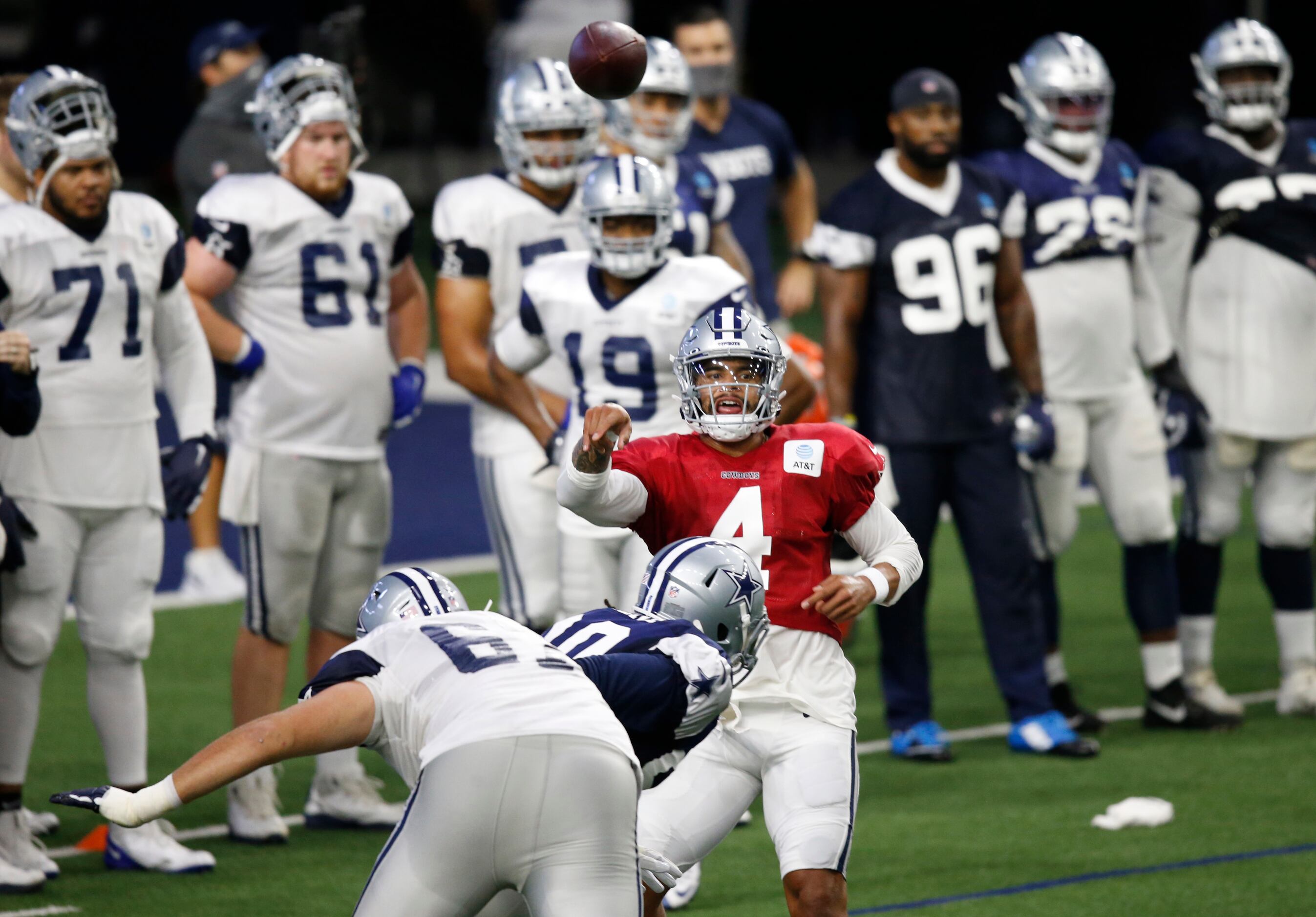 Dallas Cowboys quarterback Dak Prescott (4) passes the ball as Dallas Cowboys defensive end...