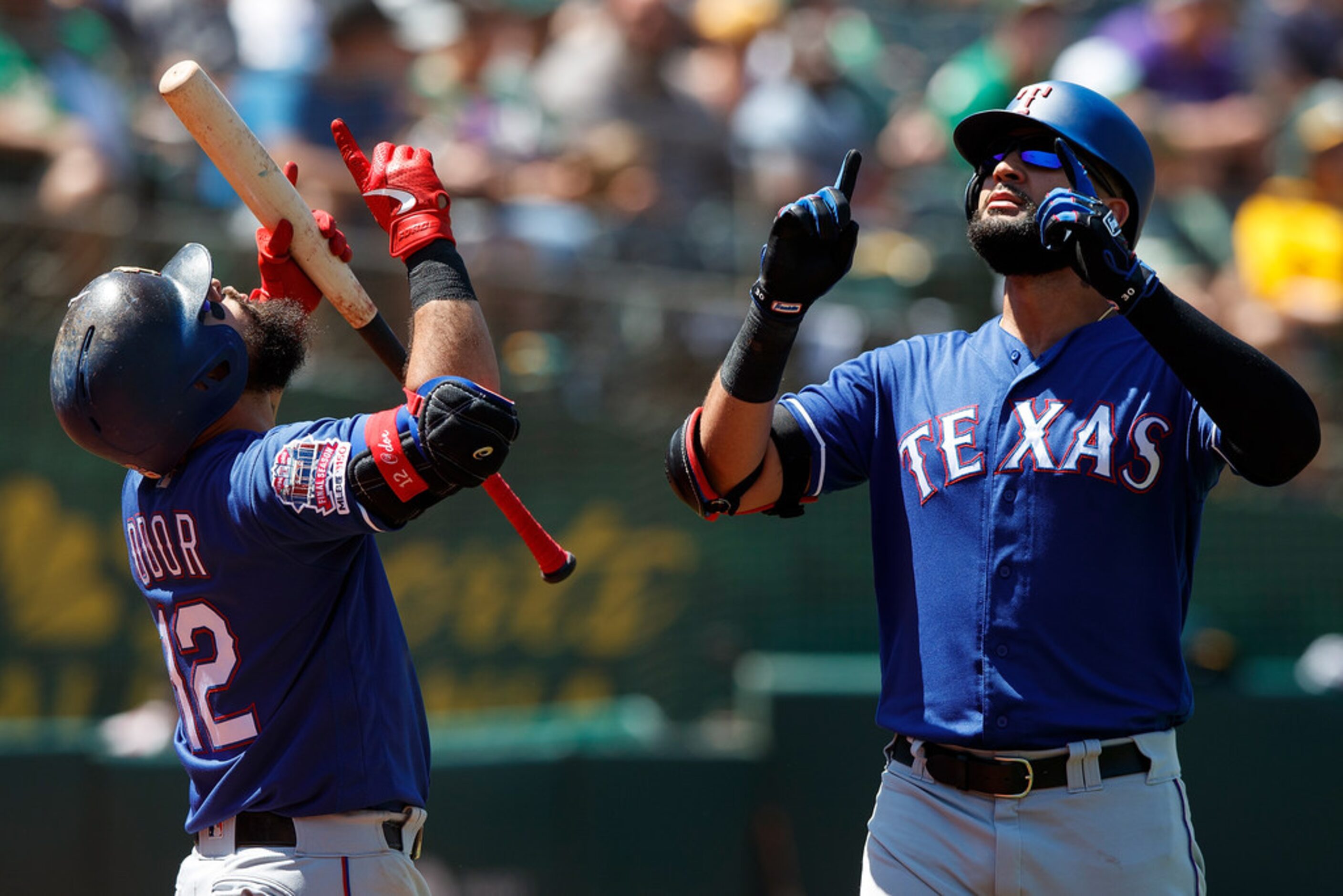 OAKLAND, CA - JULY 28:  Nomar Mazara #30 of the Texas Rangers is congratulated by Rougned...