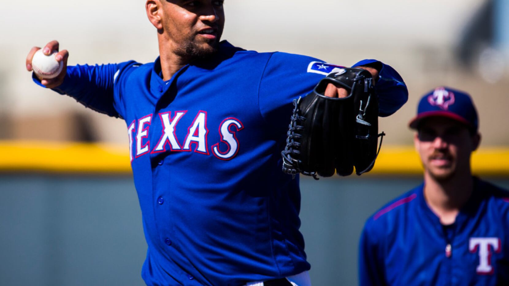 Texas Rangers starting pitcher Tyson Ross (44) throws to first base during a workout at the...