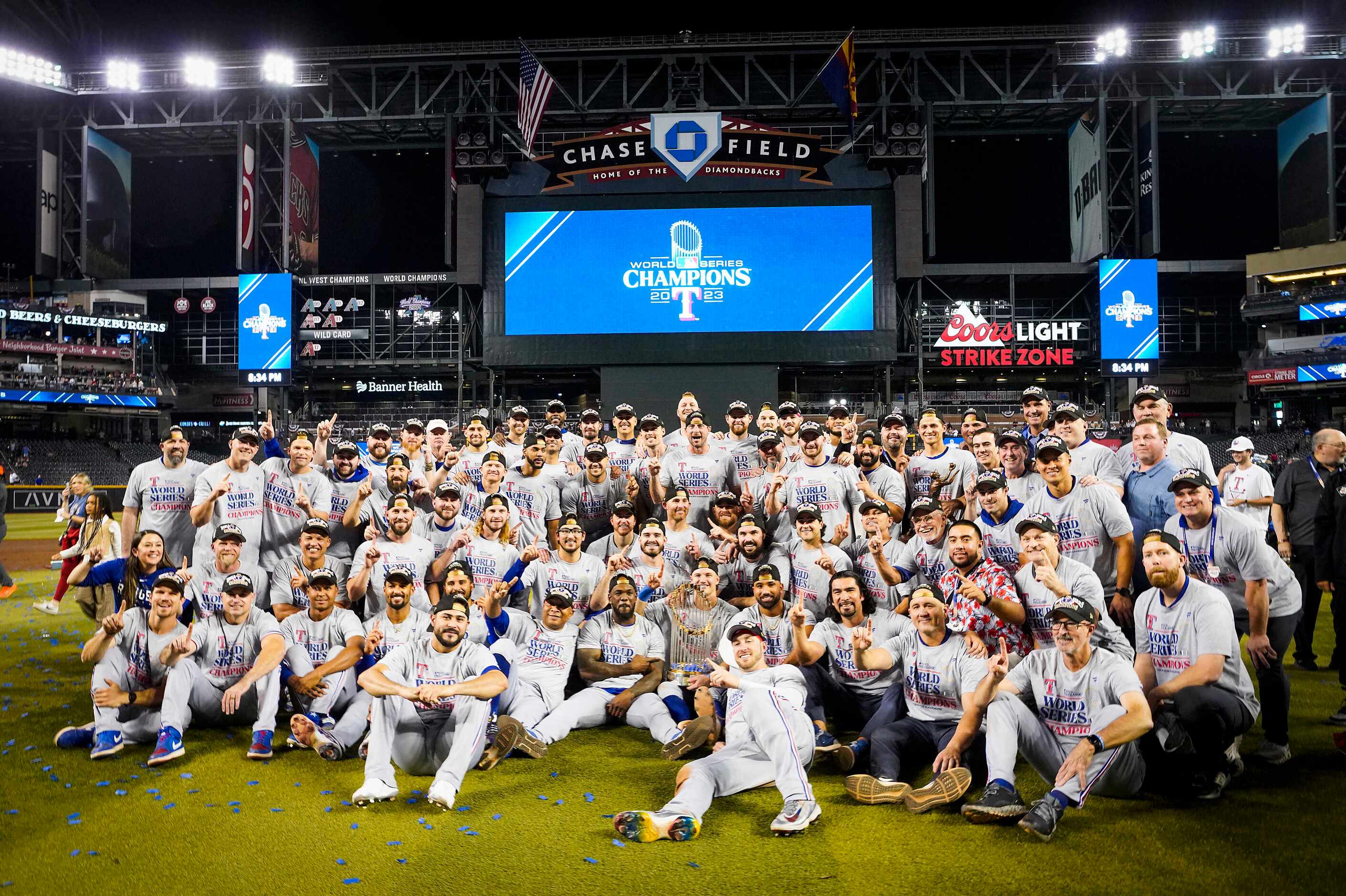 Texas Rangers players gather for a team photo as they celebrate after defeating the Arizona...