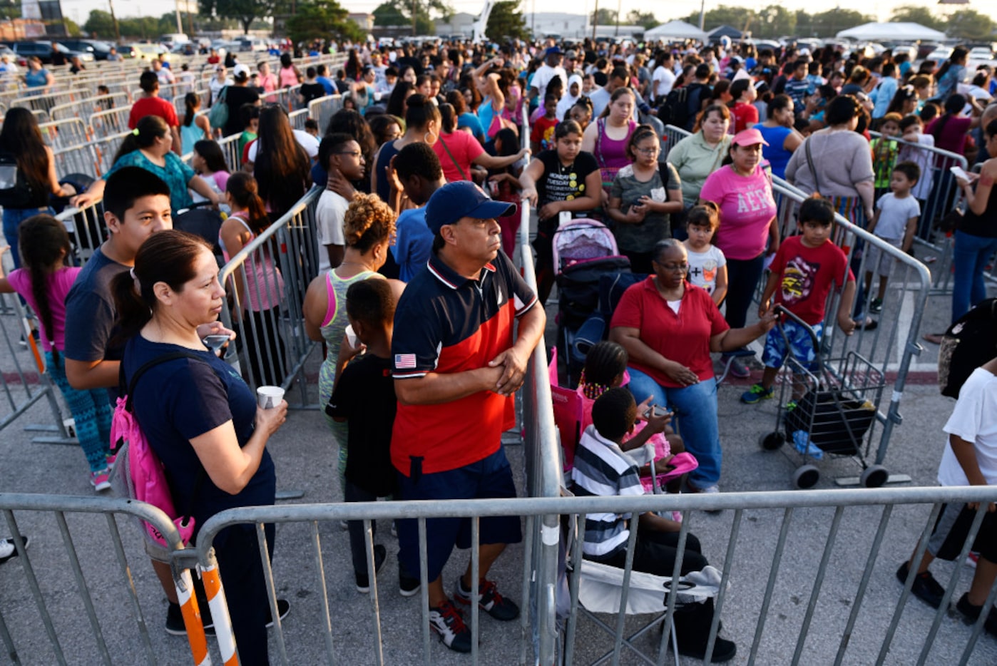 Hundreds of families wait for school supplies and health screenings during the Mayor's Back...