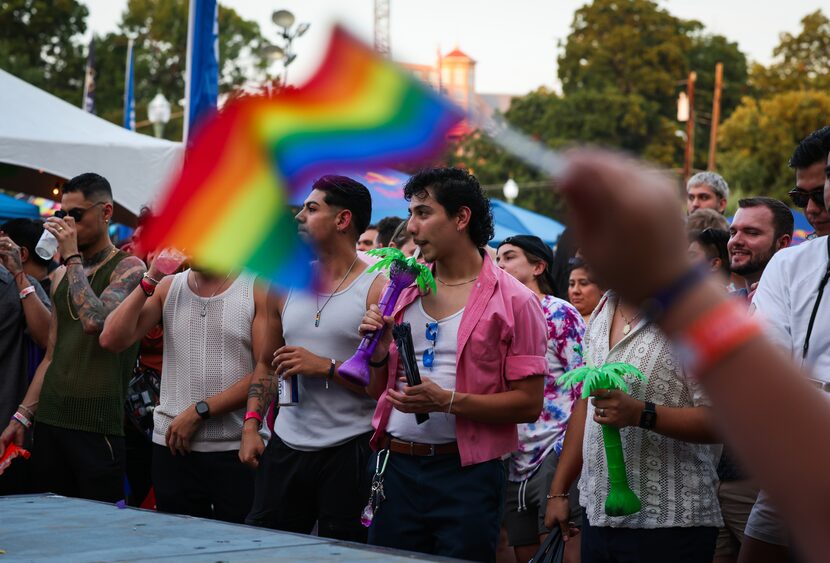 Festivalgoers watch a drag performance during the festival at Reverchon Park in Dallas.