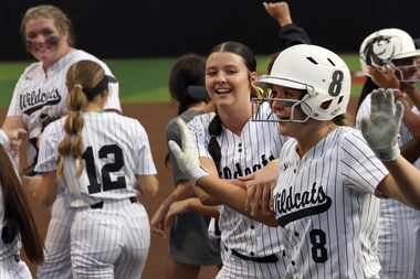 Denton Guyer catcher Jordan Osborne (8) celebrates with her twin sister, Jenna Osborne...