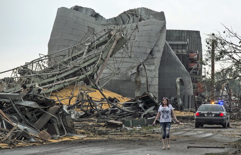 A woman walks down Black Hills Trail road in Pilger, Neb., Monday, June 16, 2014. At least...