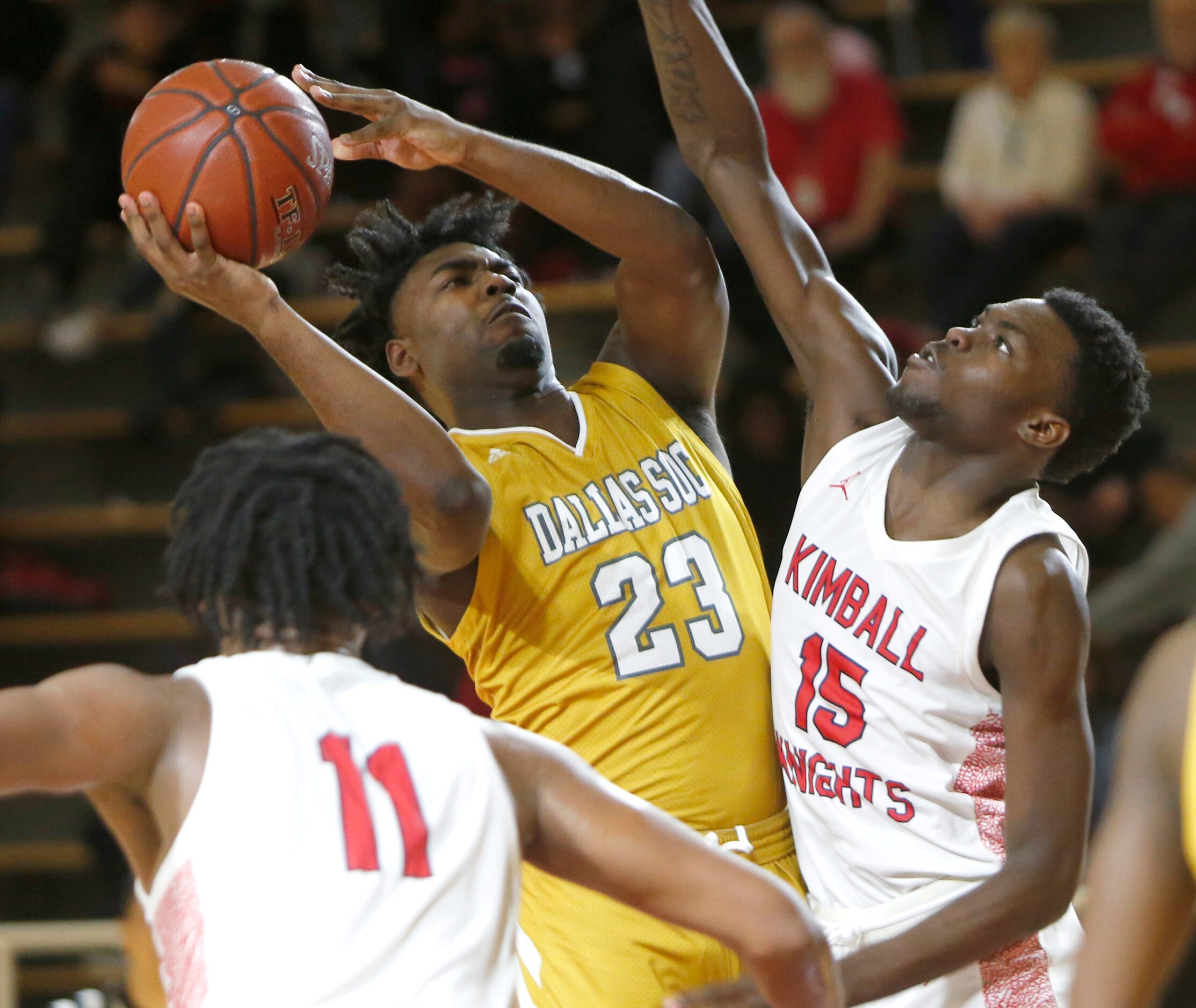 Dallas South Oak Cliff's Demetrius Thornton (23) squeezes a shot past the defense of Dallas...