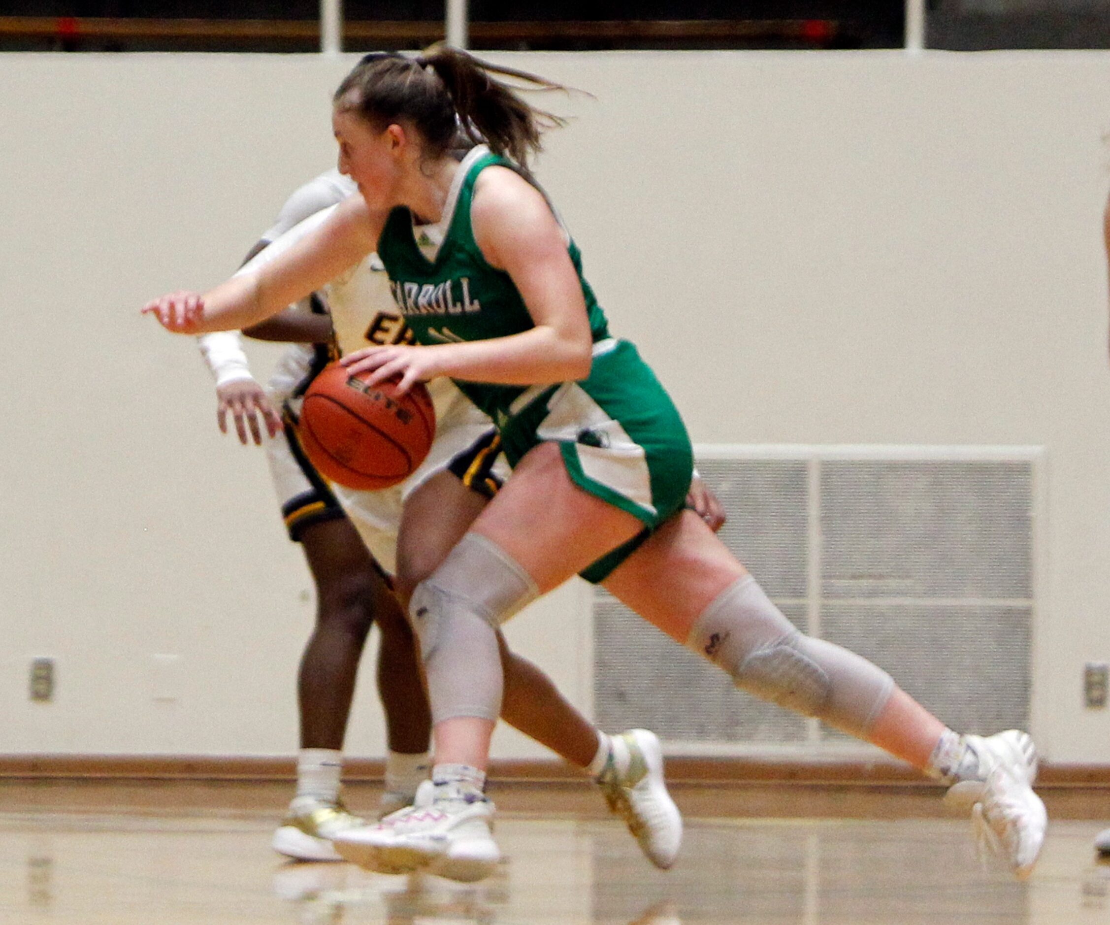 Southlake Carroll guard Kaelyn Riley (11) drives at the top of the key against the Plano...