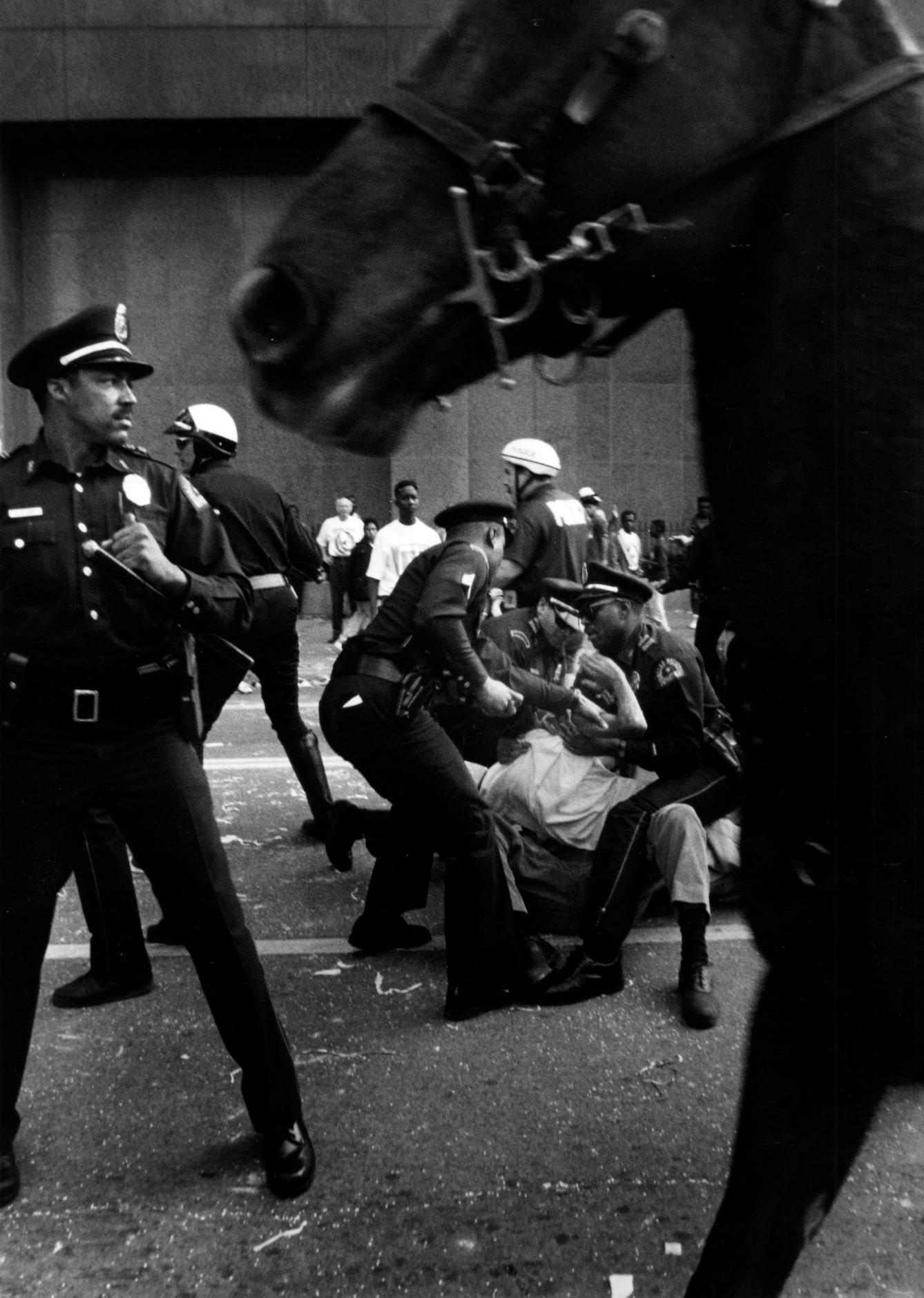 Shot February 9, 1993 - PUBLISHED February 10, 1993 - A police officer restrains a parade...