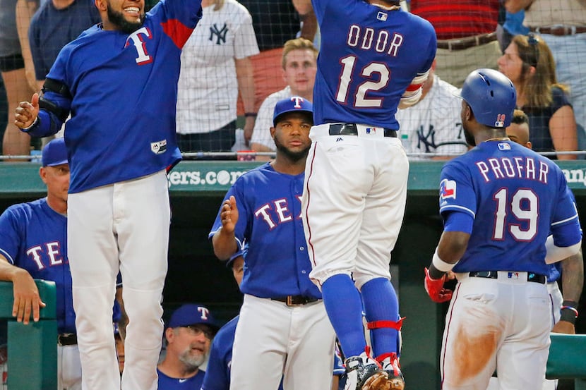 Texas Rangers second baseman Rougned Odor is congratulated teammate Elvis Andrus (1) after...