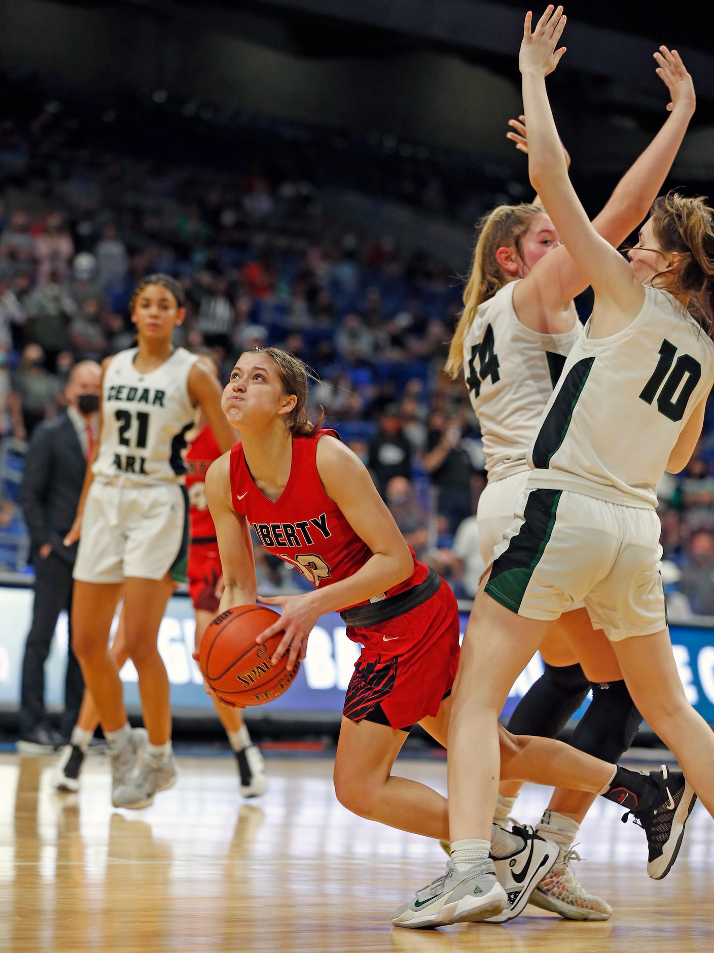 Frisco Liberty Ashley Anderson #12 drives between Cedar Park Shelby Hayes #44 and Cedar Park...