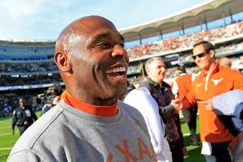 Texas head coach Charlie Strong smiles as he leaves the field after a 23-17 win over Baylor...