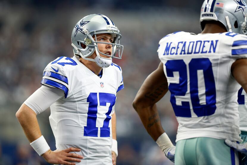 Dallas Cowboys quarterback Kellen Moore (17) waits in the huddle for a timeout to end...