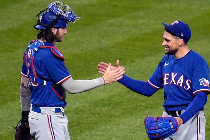 Texas Rangers starting pitcher Nathan Eovaldi, right, celebrates the team's 6-1 win over the...