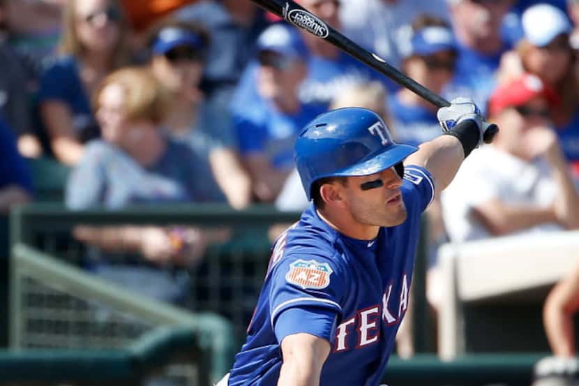 SURPRISE, AZ - MARCH 02:  Justin Ruggiano #25 of the Texas Rangers hits a single against the...
