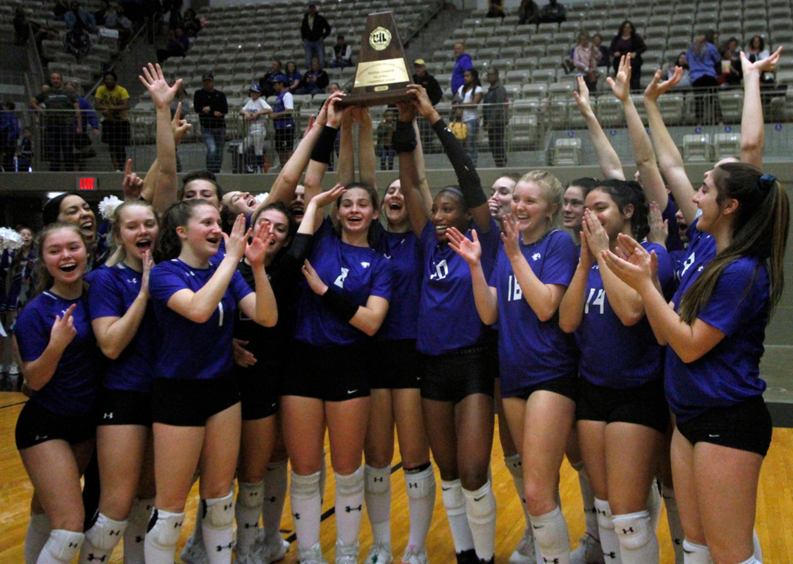 Members of the Trophy Club Byron Nelson Lady Bobcats celebrate their 25-18, 25-17, 25-16...