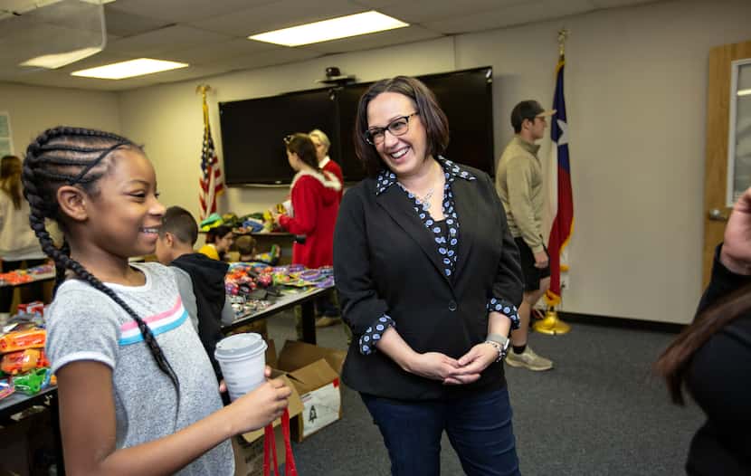 MJ Hegar chats with Azaria Jordan, 9, and her stepmother, Staff Sgt. Selina Robinson, during...