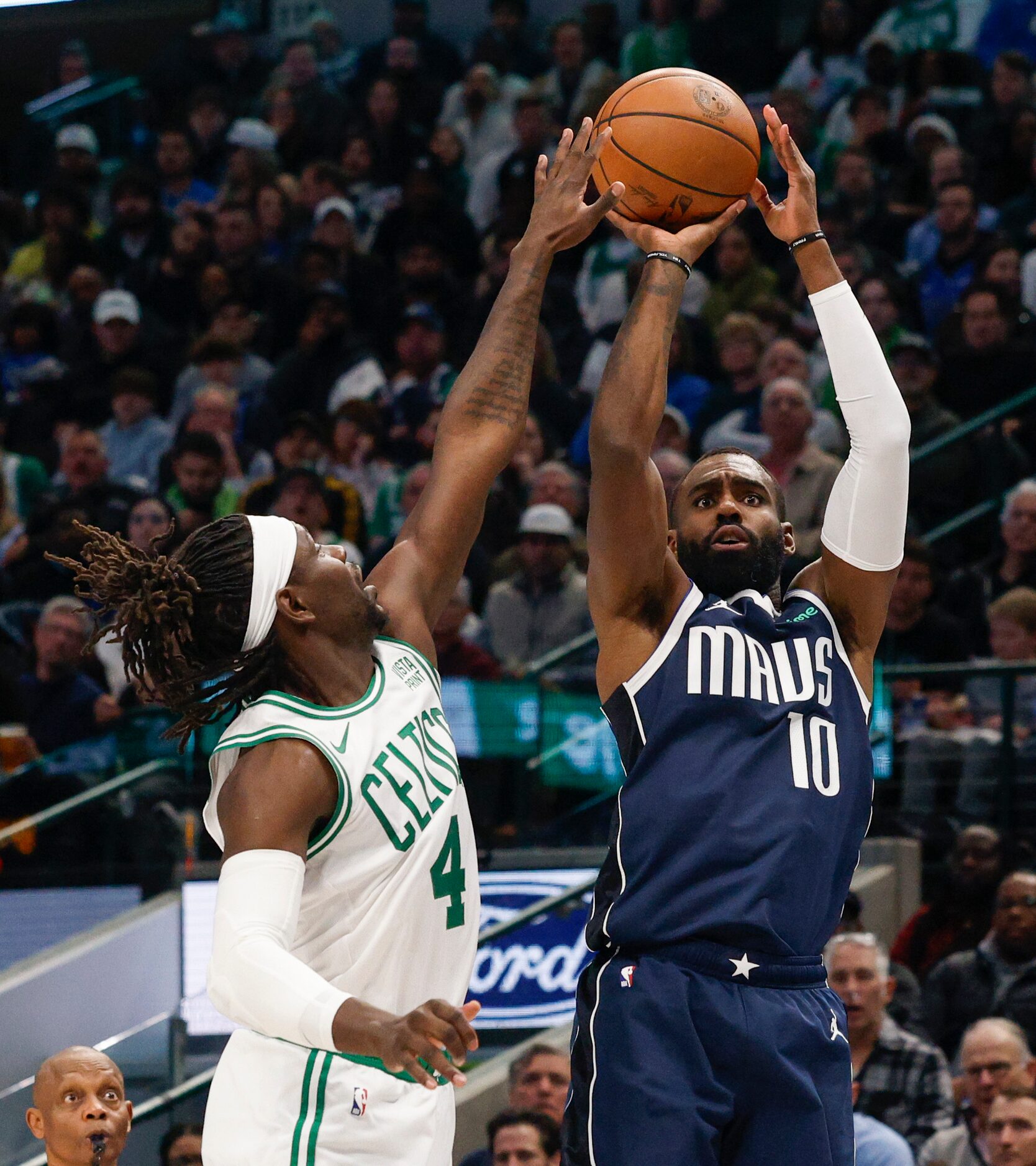 Dallas Mavericks forward Tim Hardaway Jr. (10) shoots over Boston Celtics guard Jrue Holiday...