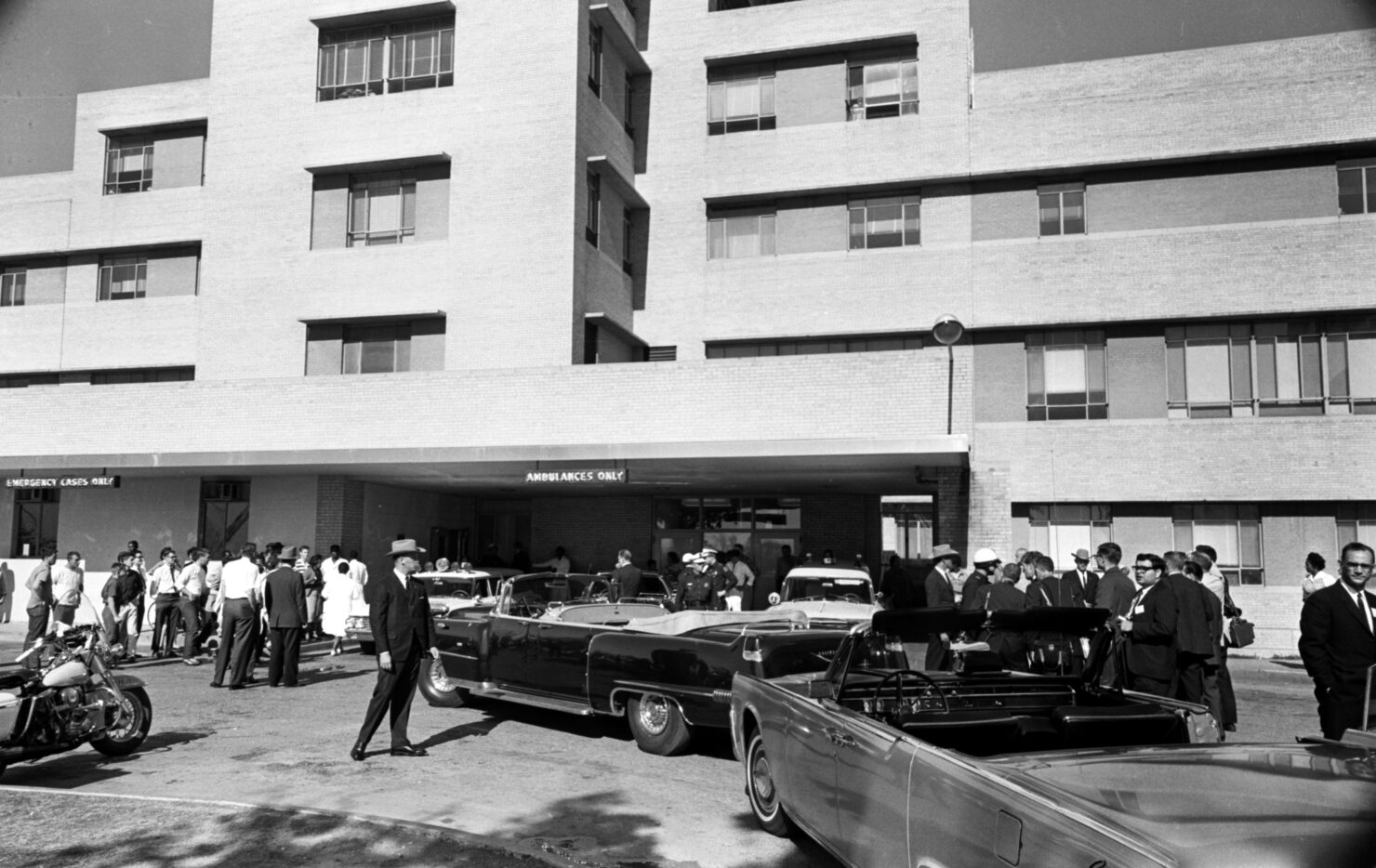 Cars from President John F. Kennedy's motorcade are parked outside the Parkland Emergency...