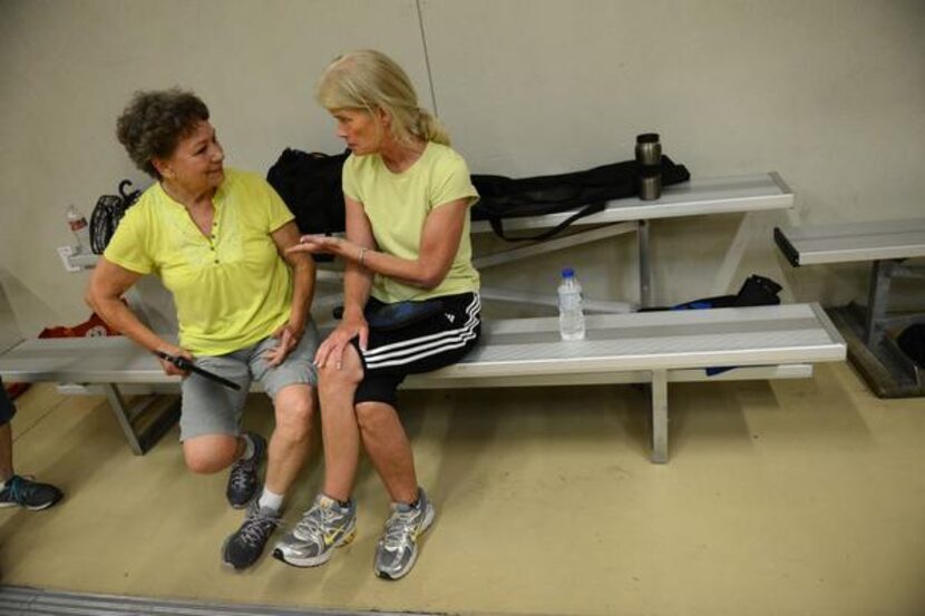 
Pickleball players Sarah Smith (left) and Casey Erickson chat in between games at the...