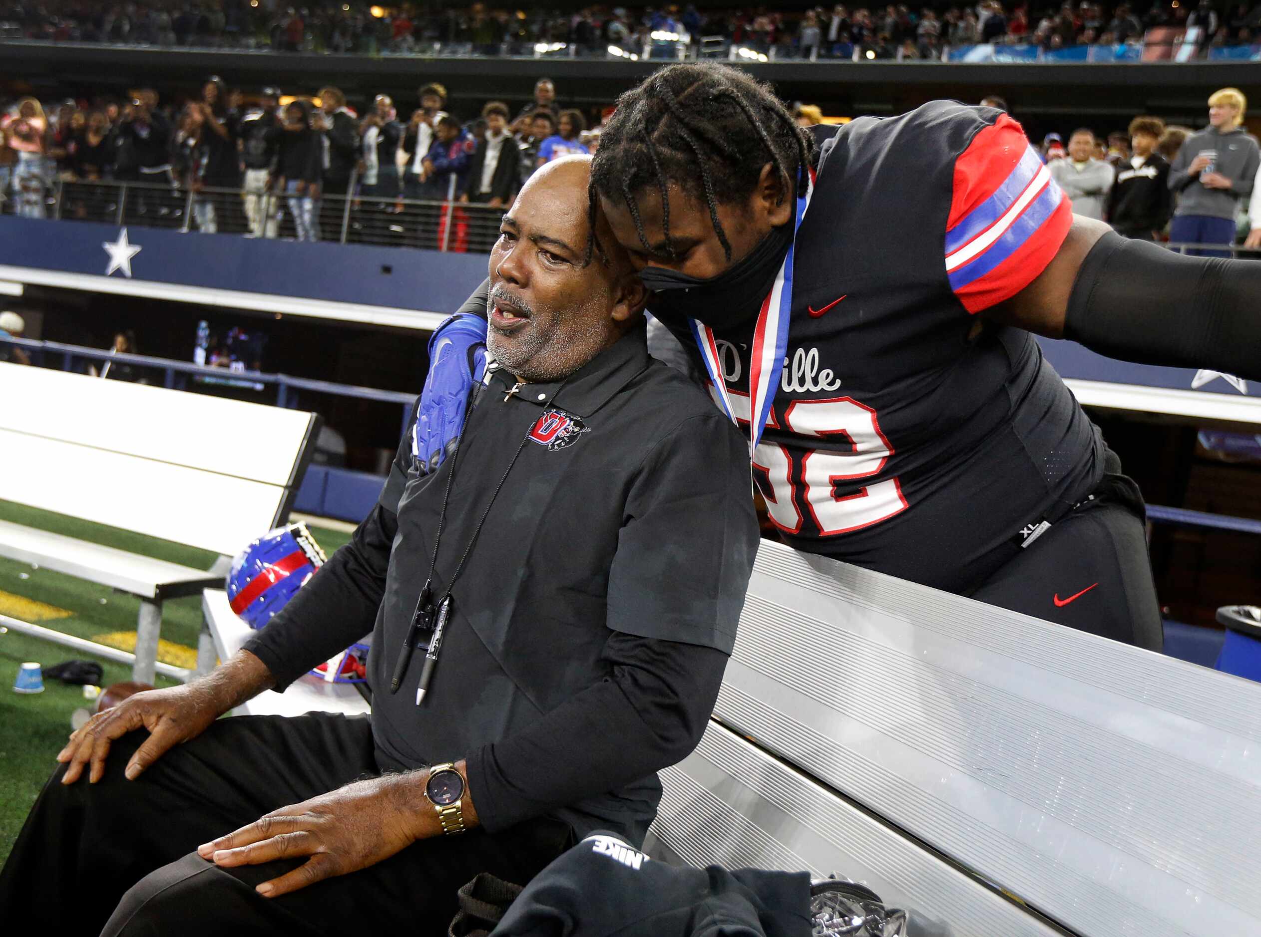 Duncanville head coach Reginald Samples took a breather on the bench as he’s hugged by...