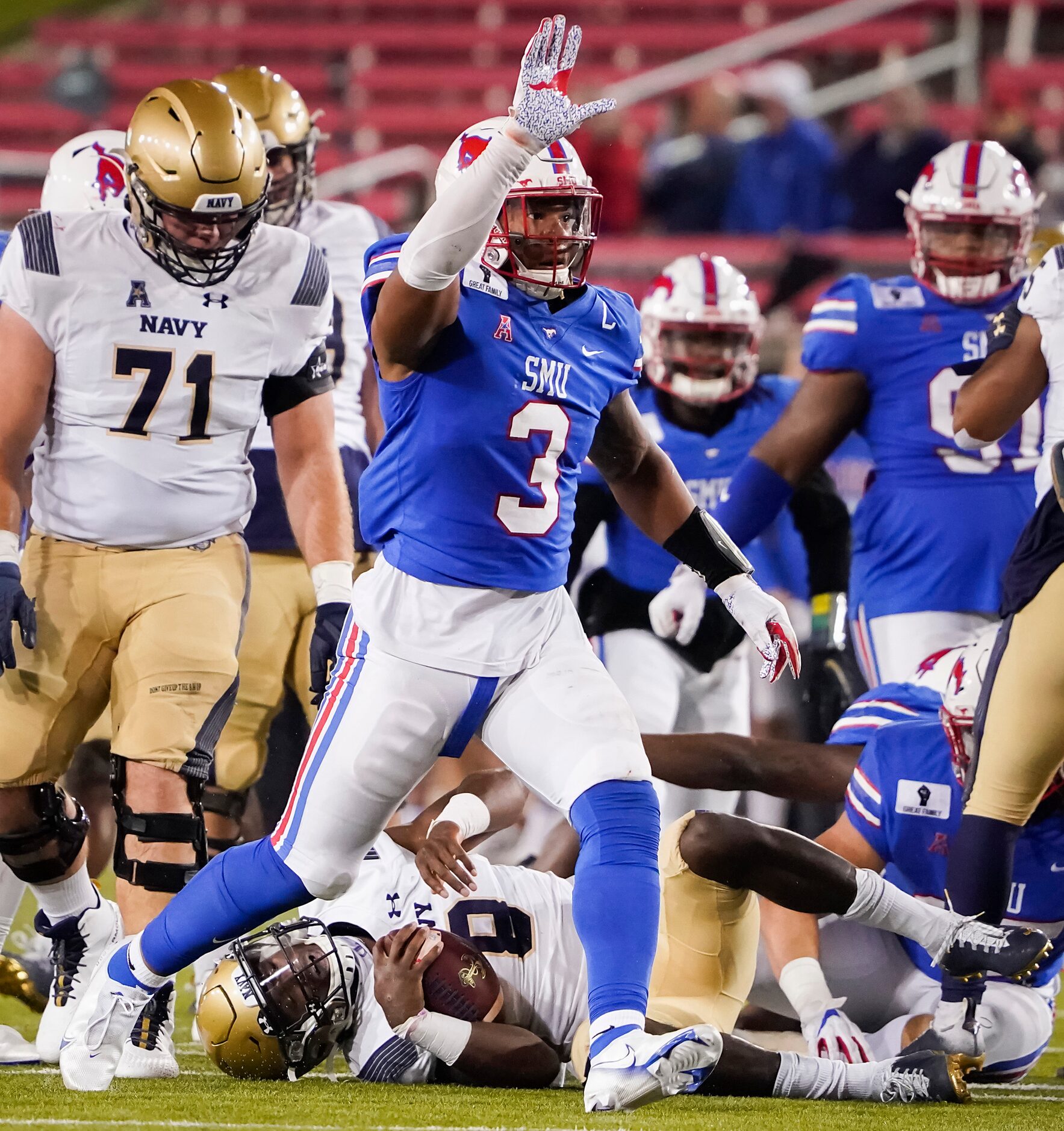 SMU linebacker Delano Robinson (3) celebrates after sacking Navy quarterback Dalen Morris...