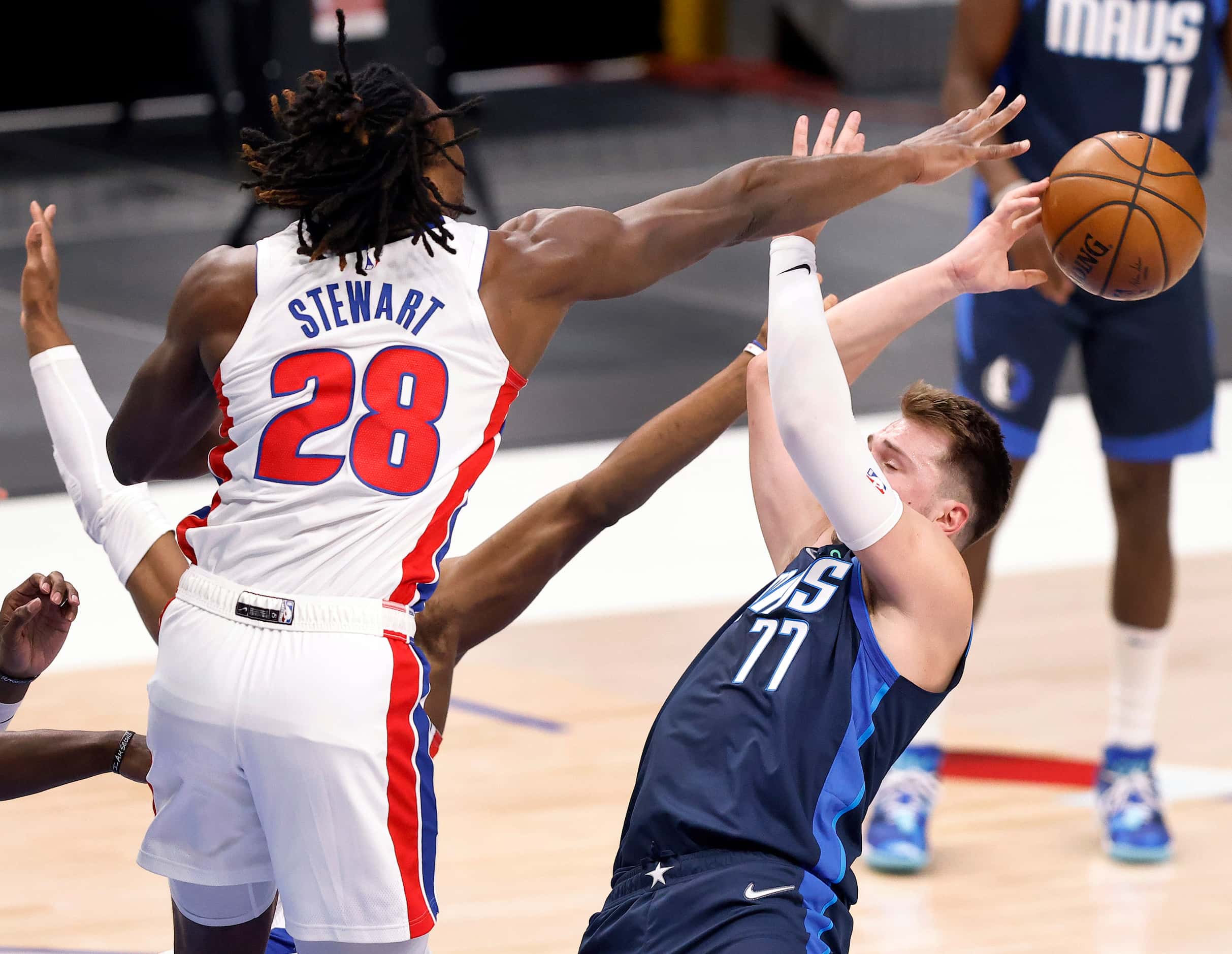 Dallas Mavericks guard Luka Doncic (77) has his driving shot knocked away by Detroit Pistons...