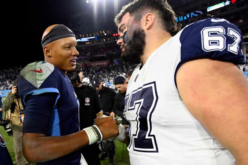 Tennessee Titans quarterback Joshua Dobbs (11) speaks with Dallas Cowboys center Brock...