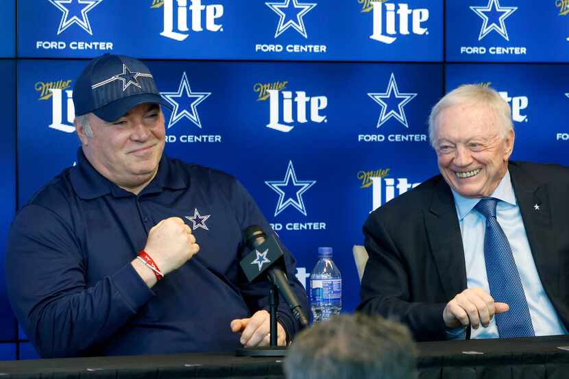 Dallas Cowboys head coach Mike McCarthy (left) makes a fist after owner Jerry Jones joked...