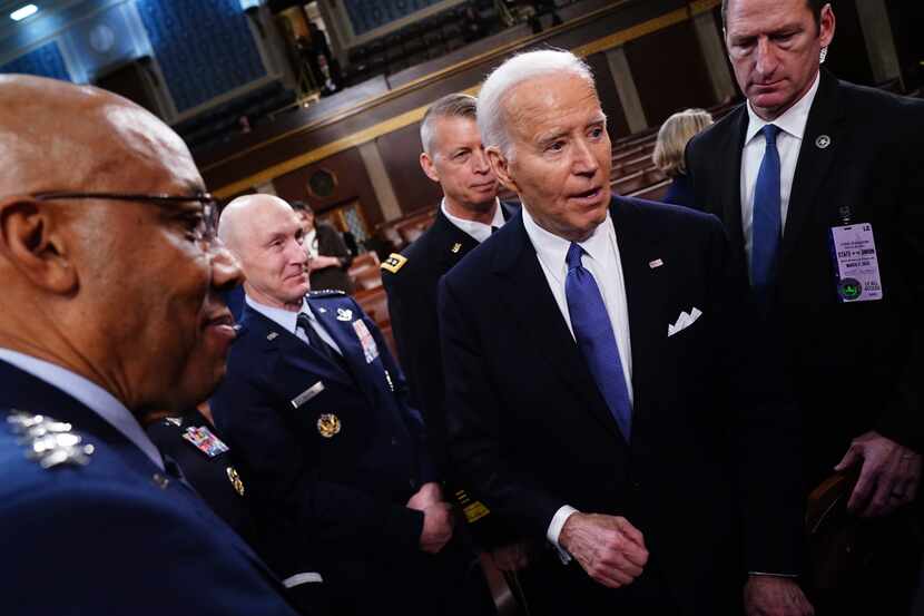 President Joe Biden, right, departs after delivering the State of the Union address to a...