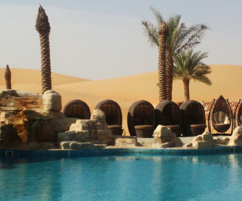 Poolside at the Arabian Nights Village hotel in the Al Khatim desert of the United Arab...