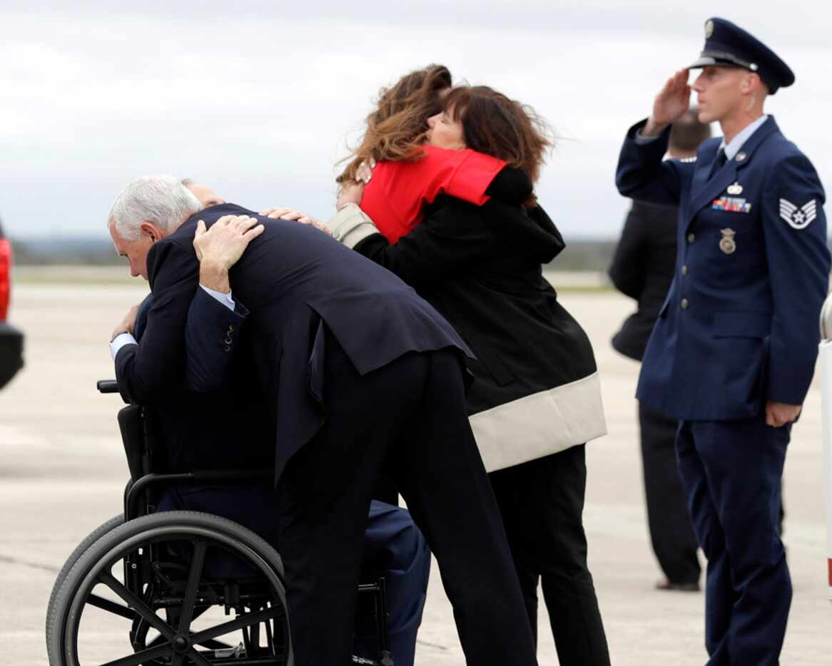 Vice President Mike Pence hugs Texas Gov. Greg Abbott as wife Karen Pence (right) shares an...